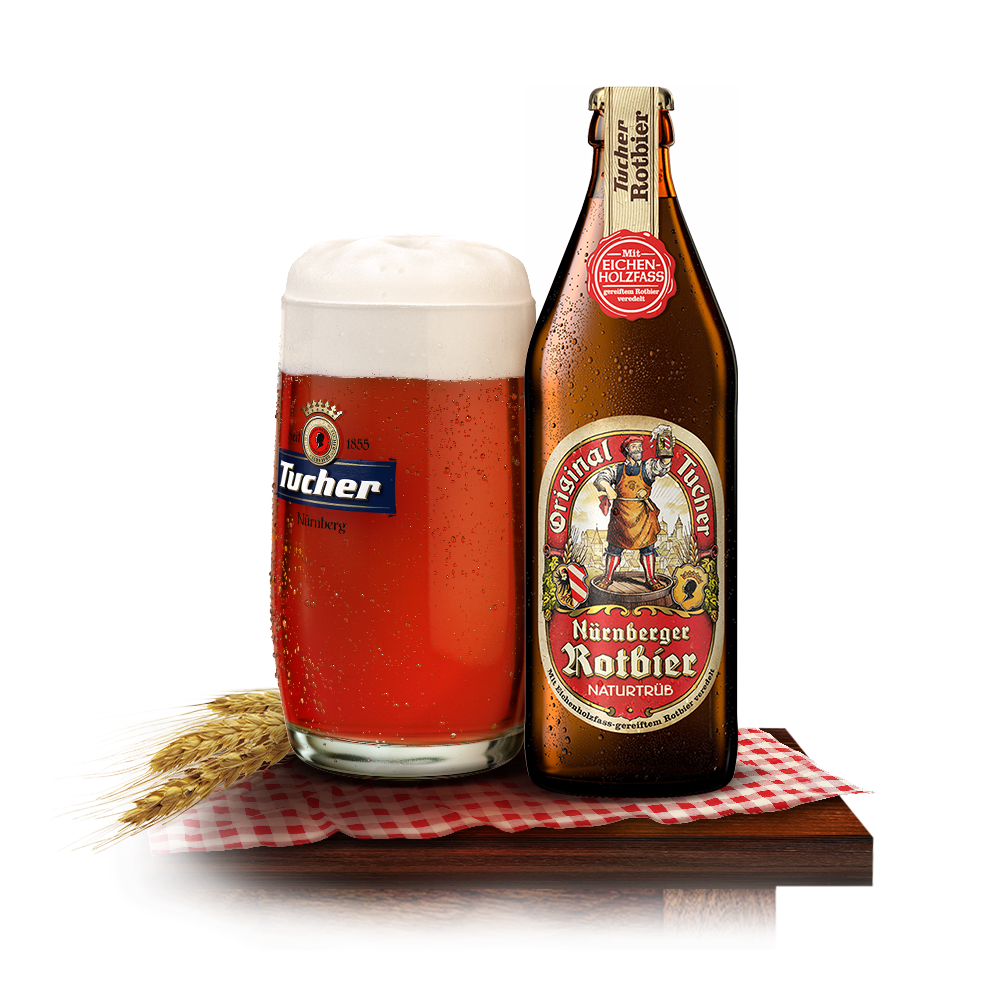 Ein Glas rotes Bier mit Schaum steht neben einer gefüllten Flasche auf einem Tisch.